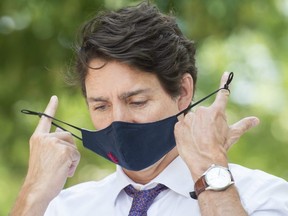 Prime Minister Justin Trudeau removes his mask during a childcare funding announcement in Montreal, Thursday, August 5, 2021.