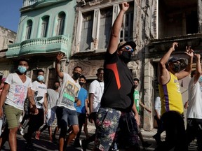 People shout slogans against the government during a protest against and in support of the government, amidst the COVID-19 outbreak, in Havana, Cuba, July 11, 2021.