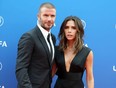Former English football player David Beckham and his wife Victoria arrive to attend the draw for UEFA Champions League football tournament at The Grimaldi Forum in Monaco on August 30, 2018.
