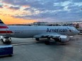 An American Airlines plane is seen at sunrise parked on the tarmac of the Reagan Washington National Airport (DCA) in Arlington, Virginia, on April 22, 2021.