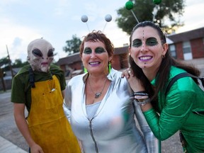 Gable Curtis (L), Laura Curtis (C) and Madison Curtis (R) wear costumes during the UFO Festival on July 2, 2021 in Roswell, New Mexico.
