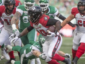 Ottawa Redblacks running back Timothy Flanders (20) carries the ball towards the end zone against the Saskatchewan Roughriders on Saturday night in Regina.