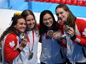 Canadian bronze medallists (from left) Kylie Masse, Sydney Pickrem, Margaret Mac Neil and Penny Oleksiak pose with their medals after the final of the women's 4x100m medley relay swimming event during the Tokyo 2020 Olympic Games at the Tokyo Aquatics Centre on Aug. 1, 2021.