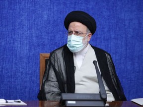 A handout picture provided by the Iranian presidency on August 4, 2021 shows Iran's new President Ebrahim Raisi meeting with the National Task Force for Fighting Coronavirus (COVID-19) in Tehran.
