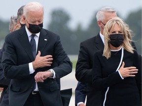U.S. President Joe Biden looks down alongside First Lady Jill Biden as they attend a Dignified Transfer ceremony at Dover Air Force Base in Dover, Del., on Aug. 29, 2021.