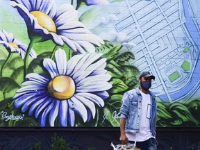 File photo/ A man wears a mask as he shops in the Glebe.