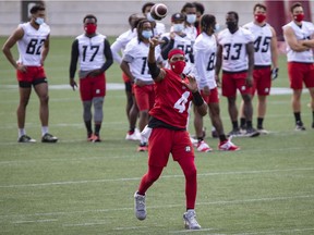 Ottawa Redblacks QB Dominique Davis throws a pass at training camp in July 2021. On Tuesday, coach Paul LaPolice wasn't ready to say who would start at quarterback this week.