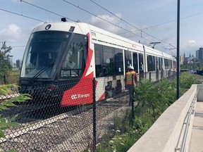 LRT workers walked alongside a slow-moving double-car train during a heat wave on Wednesday to make sure the city asset got back to the maintenance facility at Belfast Yard without any more damage.
