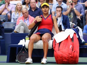Emma Raducanu takes an injury timeout after cutting her knee while sliding for a ball as she plays against Leylah Annie Fernandez of Canada in the U.S. Open final on Sept. 11, 2021.