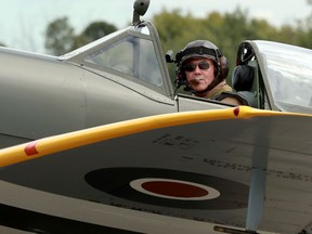 A pilot in a Spitfire taxying onto the runway before takeoff.