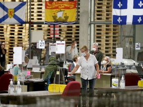 Special ballots from national and international Canadian Forces and incarcerated electors were being counted in the "counting cage" at Elections Canada Distribution Centre Monday evening.