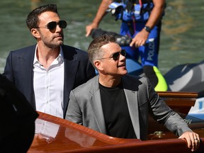 Ben Affleck (left) and Matt Damon arrive by taxi boat to attend a photocall for the film "The Last Duel" presented out of competition on September 10, 2021 during the 78th Venice Film Festival at Venice Lido.