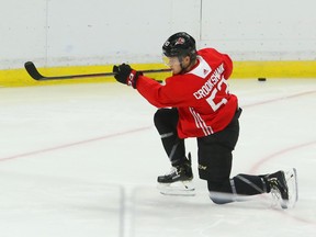 Angus Crookshank shoots on Zach Papytsakis of the Ottawa Senators at the Canadian Tire Centre in Ottawa on Monday.