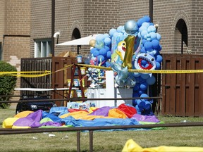 A balloon birthday display for a one-year-old is part of the crime scene as Toronto Police sift through the area where a multi-victim shooting occurred at a housing complex on Tandridge Cres. off of Albion Rd. Saturday, June 19, 2021.