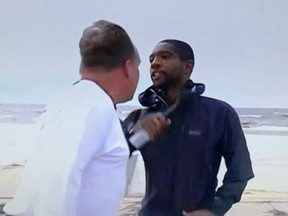 NBC News reporter Shaquille Brewster, right, is attacked during a live report on Hurricane Ida in Gulfport, Miss.