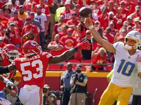 Los Angeles Chargers quarterback Justin Herbert (10) throws a pass as Kansas City Chiefs inside linebacker Anthony Hitchens (53) defends during the second half at GEHA Field at Arrowhead Stadium Sept. 26, 2021.