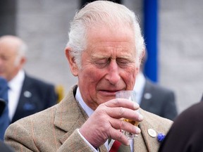 Britain's Prince Charles, Prince of Wales has a dram of whisky before officially opening the Lerwick Fishmarket, Mair's Quay and the Scalloway Fish Market, at Shetland Seafood Auctions Ltd, Lerwick Fishmarket in Lerwick, Shetland on July 30, 2021, the second day of a two-day visit to Scotland.