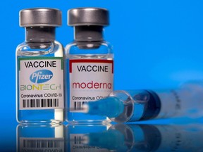 Vials with Pfizer-BioNTech and Moderna coronavirus disease (COVID-19) vaccine labels are seen in this illustration picture taken March 19, 2021.