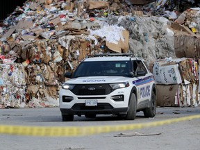 Ottawa police investigate the scene at a recycling yard on Sheffield Road on Friday.