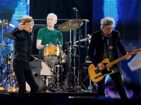 Mick Jagger (left), Charlie Watts (centre) and Keith Richards of the Rolling Stones perform during a concert in Abu Dhabi, Feb. 21, 2014.