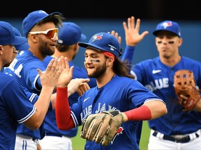 Blue Jays shortstop Bo Bichette celebrates with teammates after defeating the Tampa Bay Rays at the Rogers Centre on Wednesday, Sept. 15, 2021.