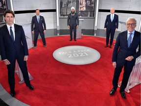 Canadian Prime Minister and leader of the Liberal party Justin Trudeau (left), Bloc Quebecois Leader Yves-Francois Blanchet, NDP Leader Jagmeet Singh, Conservative Leader Erin O'Toole and Canadian journalist Pierre Bruneau pose for the official photo at the TVA studios ahead of the Face-a-Face 2021 debate in Montreal on Sept. 2, 2021.