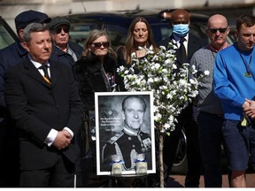London Black Cab taxi drivers observe a minute's silence during the funeral of Britain's Prince Philip, husband of Queen Elizabeth, who died at the age of 99, on The Mall in London, Britain, April 17, 2021.