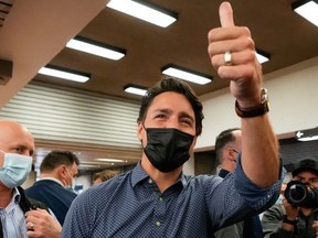 Canada's Liberal Prime Minister Justin Trudeau gestures as he greets supporters, after the Liberals won a minority government, at the Jarry Metro station in Montreal, Quebec, Canada, September 21, 2021.