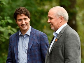 Prime Minister Justin Trudeau, left, speaks with B.C. Premier John Horgan at Town Centre Park in Coquitlam onJuly 8.