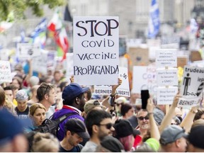 People attend a protest against the Quebec government's measures to help curb the spread of COVID-19 in Montreal, Sunday, September 5, 2021, as the COVID-19 pandemic continues in Canada and around the world.
