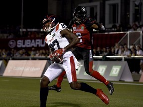 Montreal Alouettes wide receiver Eugene Lewis receives the ball for a touchdown against Ottawa Redblacks defensive back Randall Evans in Ottawa on Friday, Sept. 3, 2021. After that 51-29 loss, it seems everyone has an opinion on what the Redblacks need to do to solve their problems.