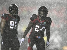 Ottawa Redblacks linebacker Micah Awe (24) celebrates tackling Hamilton Tiger-Cats wide receiver Papi White (4), not shown, during first half CFL football action in Ottawa on Wednesday, Sept. 22, 2021.