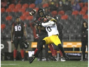Hamilton Tiger-Cats defensive back Ciante Evans (0) knocks down the ball intended for Ottawa Redblacks slotback Kenny Stafford (85) during first half CFL football action in Ottawa on Wednesday, Sept. 22, 2021.