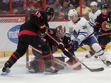 Ottawa Senators goalie Filip Gustavsson (32) makes a save in front of Toronto Maple Leafs centre Kirill Semyonov (94) in the first period at the Canadian Tire Centre.