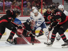 Ottawa Senators goalie Filip Gustavsson (32) makes a save in front of Toronto Maple Leafs center Kirill Semyonov (94) in the first period at the Canadian Tire Centre on Wednesday.