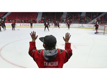 A young fan watches the Senators warm up before the game.