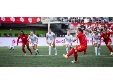 Canada's Jessie Fleming scores on a first-half penalty kick against New Zealand.