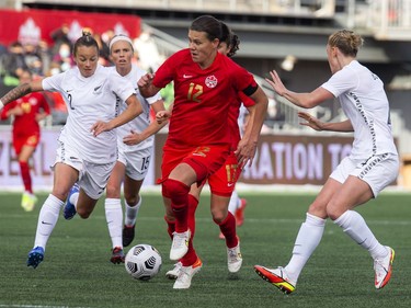 Canada's Christine Sinclair brings the ball down the field during the game.