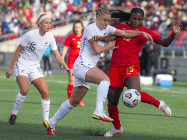 New Zealand's C.J. Bott battles Canada's Nichelle Prince for the ball.