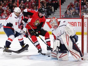 Chris Tierney #71 of the Ottawa Senators gets the puck past Ilya Samsonov #30 of the Washington Capitals for a second period short-handed goal as Alex Ovechkin #8 of the Washington Capitals defends the net at Canadian Tire Centre on January 31, 2020.