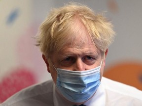 Prime Minister Boris Johnson wears a face mask as he visits Colchester hospital on May 27, 2021 in Colchester, United Kingdom.