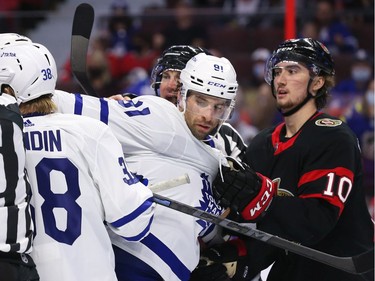 Alex Formenton #10 of the Ottawa Senators pulls John Tavares #91 of the Toronto Maple Leafs out of a scrum in the second period at Canadian Tire Centre.