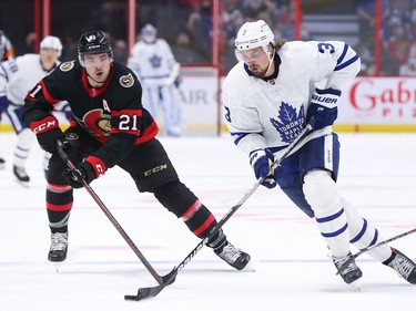 Ottawa's Nick Paul chases after Justin Holl of the Toronto Maple Leafs during the third period at Canadian Tire Centre on Thursday night in the Senators' season opener.