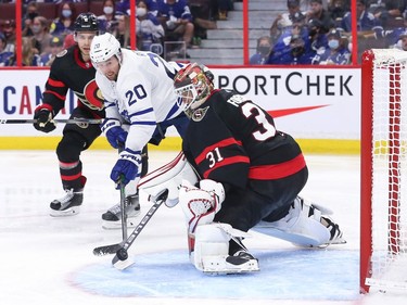 Anton Forsberg #31 of the Ottawa Senators makes a stick save against Nick Ritchie #20 of the Toronto Maple Leafs in the third period at Canadian Tire Centre on Oct. 14, 2021.