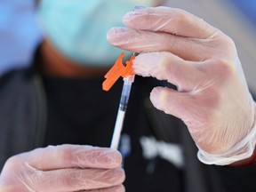 A medical staff member prepares a COVID-19 vaccine.