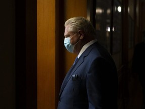Ontario Premier Doug Ford returns to his office following a press briefing at the Queens Park Legislature in Toronto on Friday, October 15, 2021.