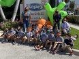 Elementary school students and chaperones posing outside a Florida bar and grill.
