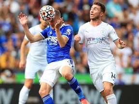 Leicester City striker Jamie Vardy (left) heads the ball away from Manchester City defender Aymeric Laporte during a Premier League match at King Power Stadium in Leicester, England, Sept. 11, 2021.