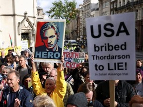 Supporters of Wikileaks founder Julian Assange protest outside the Royal Courts of Justice in London, England, Wednesday, Oct. 27, 2021.
