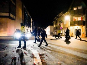Police officers cordon off the scene where they are investigating in Kongsberg, Norway after a man armed with a bow and arrows killed several people before he was arrested by police, Wednesday, Oct. 13, 2021.